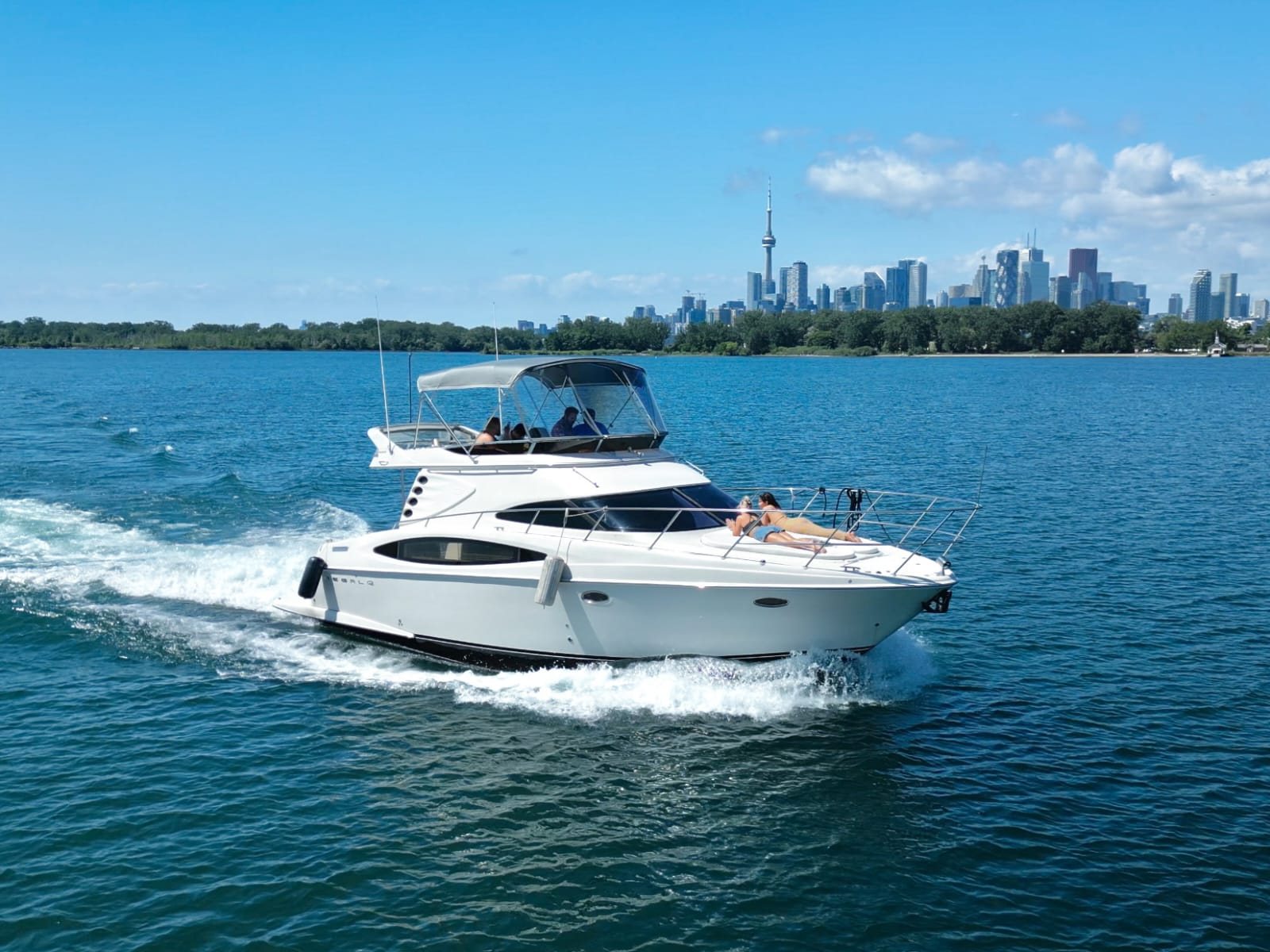 Rumba yacht cruising Lake Ontario with the Toronto skyline behind it